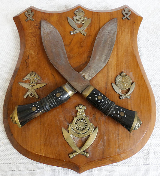 Two Gurka Kikri Knives Mounted Onto Shield Shaped Wooden Plate with Metal Cap Badges