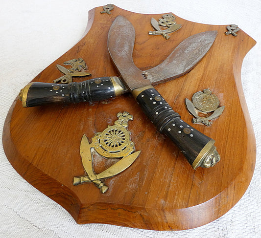 Two Gurka Kikri Knives Mounted Onto Shield Shaped Wooden Plate with Metal Cap Badges