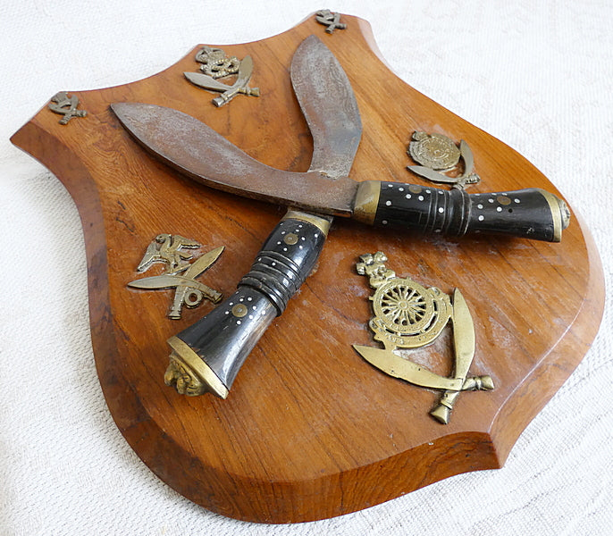 Two Gurka Kikri Knives Mounted Onto Shield Shaped Wooden Plate with Metal Cap Badges