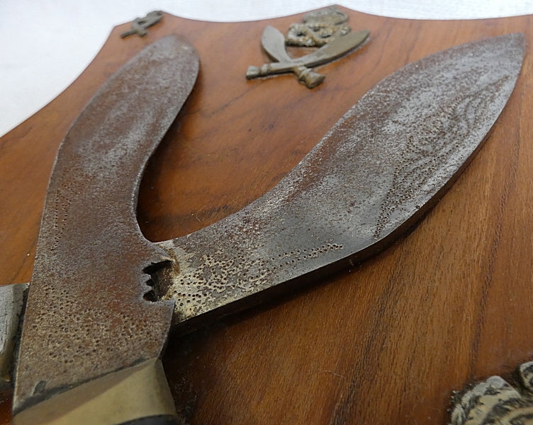 Two Gurka Kikri Knives Mounted Onto Shield Shaped Wooden Plate with Metal Cap Badges